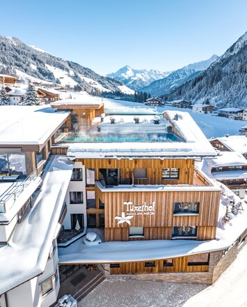 Verschneiter Tuxerhof mit beheiztem Dachpool und winterlichem Alpenpanorama