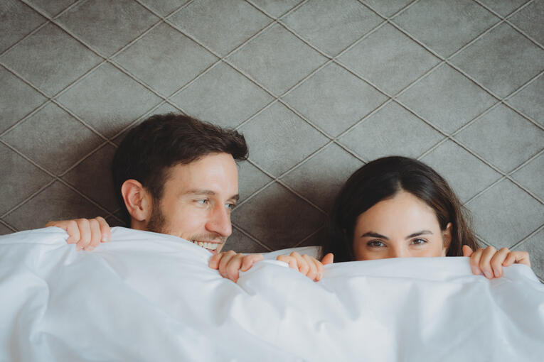 couple cuddling in their room in Tux